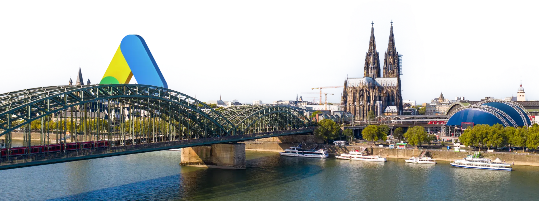 Google Ads Experten in Köln: Google-Ads-Logo über Hohenzollernbrücke und Dom